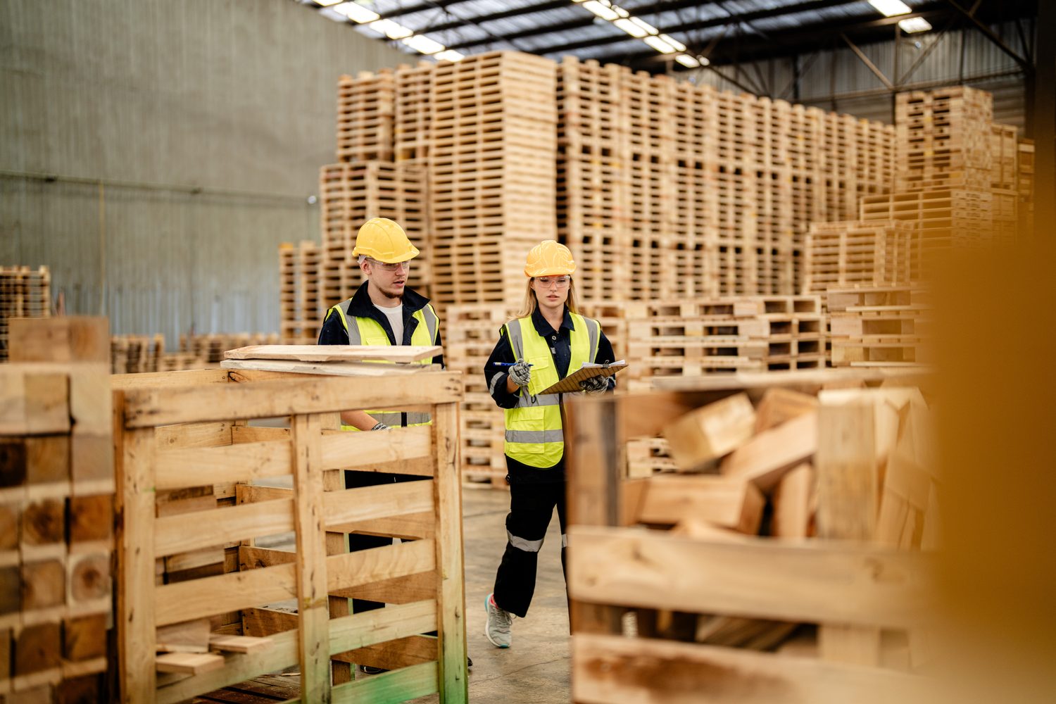 Crew inspecting and grading pallets for export compliance